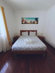 a bedroom with a bed with a tray on it at Ericeira Beach Haven in Ericeira