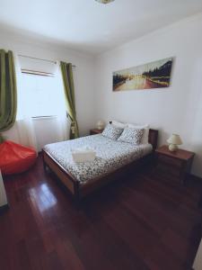 a bedroom with a bed and a window at Ericeira Beach Haven in Ericeira