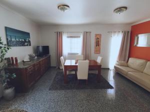 a living room with a table and a couch at Ericeira Beach Haven in Ericeira