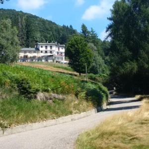 a road with a house on the side of a hill at Rifugio Campiglio in Dumenza