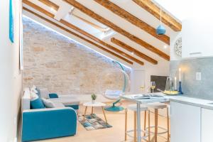 a living room with a couch and a table at Fran Center Apartments (Square) in Pula