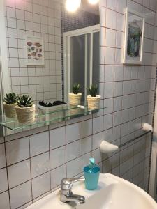 a bathroom with a sink and a mirror at Casa ANITA in Playa de Santiago +47 photos