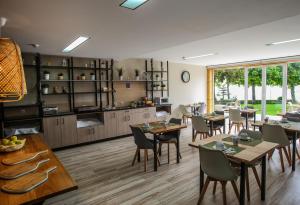 a dining room with tables and chairs and a kitchen at Paraiso Douro in Lamego