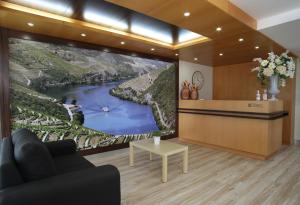 a living room with a large wall mural of a river at Paraiso Douro in Lamego