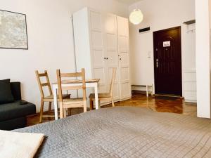 a bedroom with a bed and a table and chairs at Studio in Center in Krakow