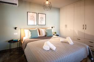 a bedroom with a bed with two towels on it at GMA - Luxury Loft Nafplio in Nafplio