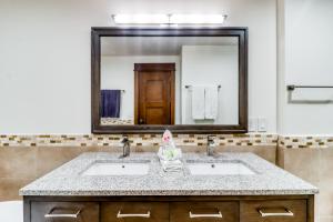 a bathroom with two sinks and a large mirror at Unit 1014 at Croc's in Jacó +25 photos