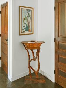 a console table in a hallway with a picture on the wall at Folly Vacation 202 Beach Bungalow in Folly Beach