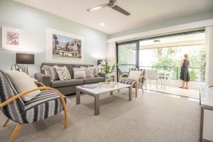 a living room with a couch and a table at Noosa Springs Golf & Spa Resort in Noosa Heads