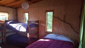 Una cama o camas en una habitación de Rustico Pucon