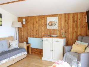 a living room with a bed and a couch at Lakeside Lodge in East Harling