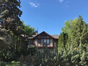 a house on the side of a hill with trees at Stirling House in Kelowna