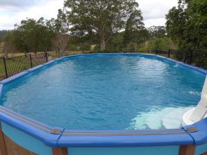 a large blue pool with a slide in it at Rural Ambience with Netflix in Mount George