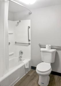 a white bathroom with a toilet and a bath tub at Gatlinburg View Lodge in Gatlinburg