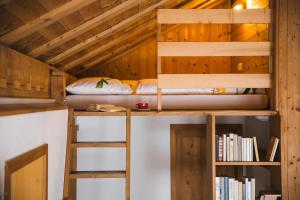 a room with two bunk beds and books at Ferienbauernhof Nigsch in Schoppernau