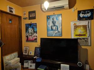 a room with a television and posters on the wall at Free parking Bito L'histoire hotel #LW178 in Tuyama