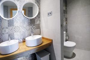 a bathroom with two sinks and a toilet at Meeting Point Hostels in Barcelona