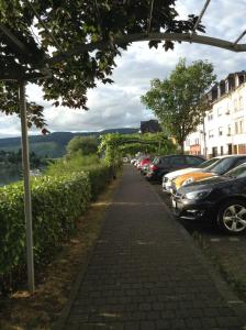a sidewalk with cars parked on the side of a street at Mosel Panorama in Zell an der Mosel