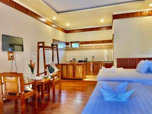 a hotel room with two beds and a kitchen at Villa Lien Tho in Phú Quốc