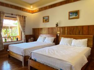 a bedroom with two beds and a window at Villa Lien Tho in Phú Quốc +93 photos