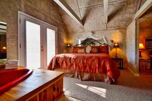 a bedroom with a bed with a red bedspread at Mountain Serenity in Gatlinburg