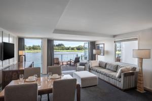 a living room with a couch and a table at Peppers Clearwater Resort in Christchurch