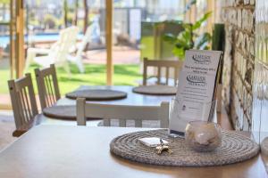 a table with a menu and a napkin on it at Lakeside Holiday Apartments Merimbula in Merimbula