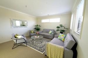 sala de estar con sofá y mesa en 6 Bedrooms Contemporary Big House at Pakenhem, en Pakenham