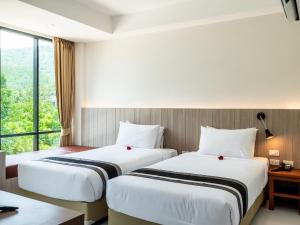 Postel nebo postele na pokoji v ubytování Ozone Hotel Khao Yai