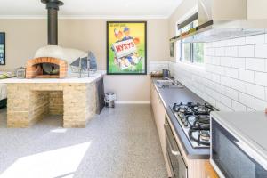 a kitchen with a stove and a pizza oven at Studio 165 Hidden Gem on 50 acres with bay views in Grantville