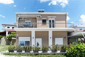 a house with a balcony in front of it at Endless sea view house in Nea Irakleia
