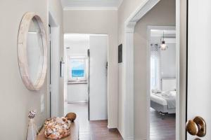 a hallway with a room with a bed and a mirror at Endless sea view house in Nea Iraklia +17 photos
