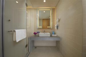 a bathroom with a sink and a mirror at Holiday Inn Express Zhengzhou Zhengdong, an IHG Hotel in Zhengzhou