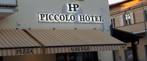 a hotel with a sign on the side of a building at Piccolo Hotel in Rosignano Solvay