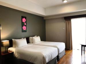 Katil atau katil-katil dalam bilik di Pulai Springs Resort Official