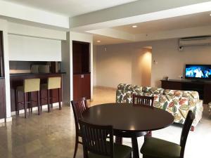 a living room with a table and a couch at Pulai Springs Resort Official in Skudai