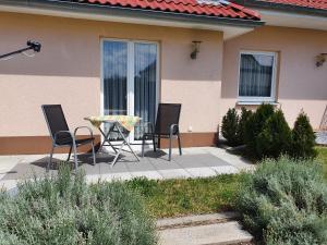 a patio with chairs and a table in front of a house at Haus Marianne in Weilheim