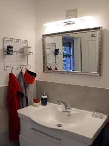a bathroom with a sink and a mirror at Ferienwohnungen Bauernschmause in Polch