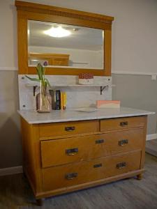 a wooden dresser with a mirror on top of it at Ferienwohnungen Bauernschmause in Polch +56 photos