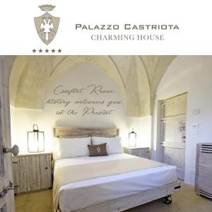 a bedroom with a bed with a sign on the wall at Palazzo Castriota in Alezio