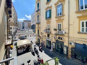 a group of motorcycles parked on a street next to buildings at AllYouCanTrip - La Nova in Naples