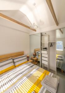 a bedroom with a large bed with yellow and white stripes at The Bakehouse in Worthing
