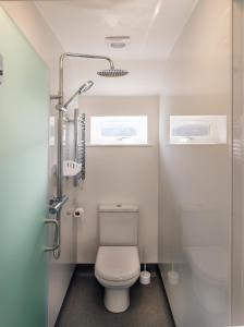 a small bathroom with a toilet and a shower at The Bakehouse in Worthing