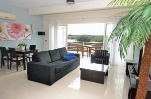 uma sala de estar com um sofá e uma sala de jantar em Colina Verde Resort em Moncarapacho
