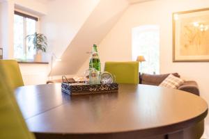 a table with a bottle and glasses on it at Ramakers Hof in Kirchlinteln