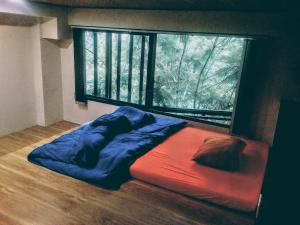 a bed in a room with a large window at Salem House in Da Lat