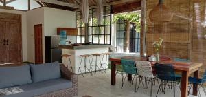 a kitchen with a table and chairs in a room at Sun Moon Star Villas in Jarakan
