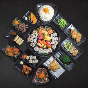 una mesa llena de diferentes tipos de sushi y comida en Brunswick Tower Hotel, en Melbourne