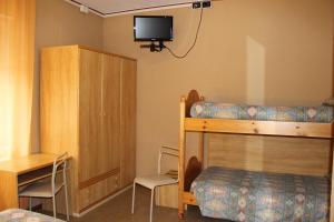a bedroom with a bunk bed and a desk at Hotel Milano in Folgaria +29 photos