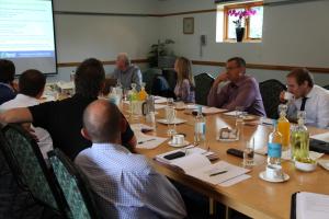 a group of people sitting around a table in a room at Ivy House Country Hotel in Lowestoft